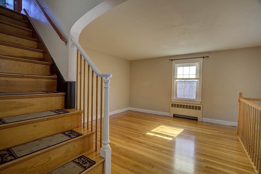 29 Perley Street Lynn, MA 01905 - Photo 12 of 27 a view of a livingroom with wooden floor and stairs