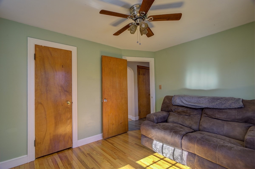29 Perley Street Lynn, MA 01905 - Photo 16 of 27 a living room with a couch and a walk in closet