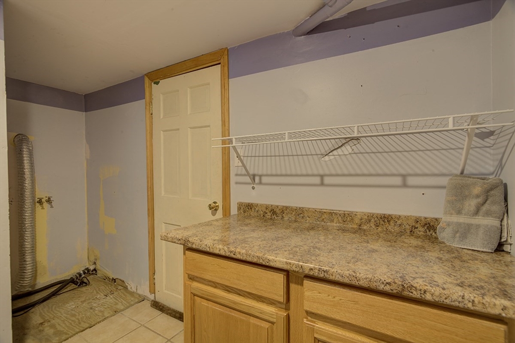 29 Perley Street Lynn, MA 01905 - Photo 20 of 27 a bathroom with a granite countertop sink and a mirror