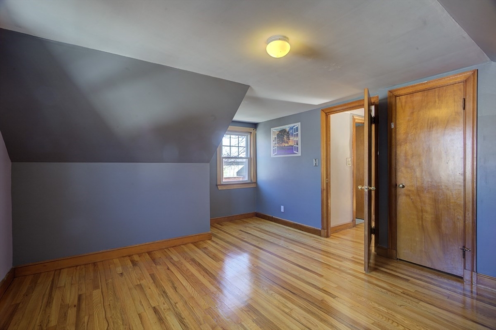 29 Perley Street Lynn, MA 01905 - Photo 21 of 27 an empty room with wooden floor and windows