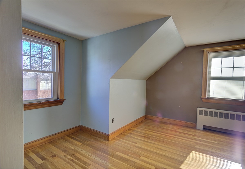 29 Perley Street Lynn, MA 01905 - Photo 25 of 27 an empty room with wooden floor and windows