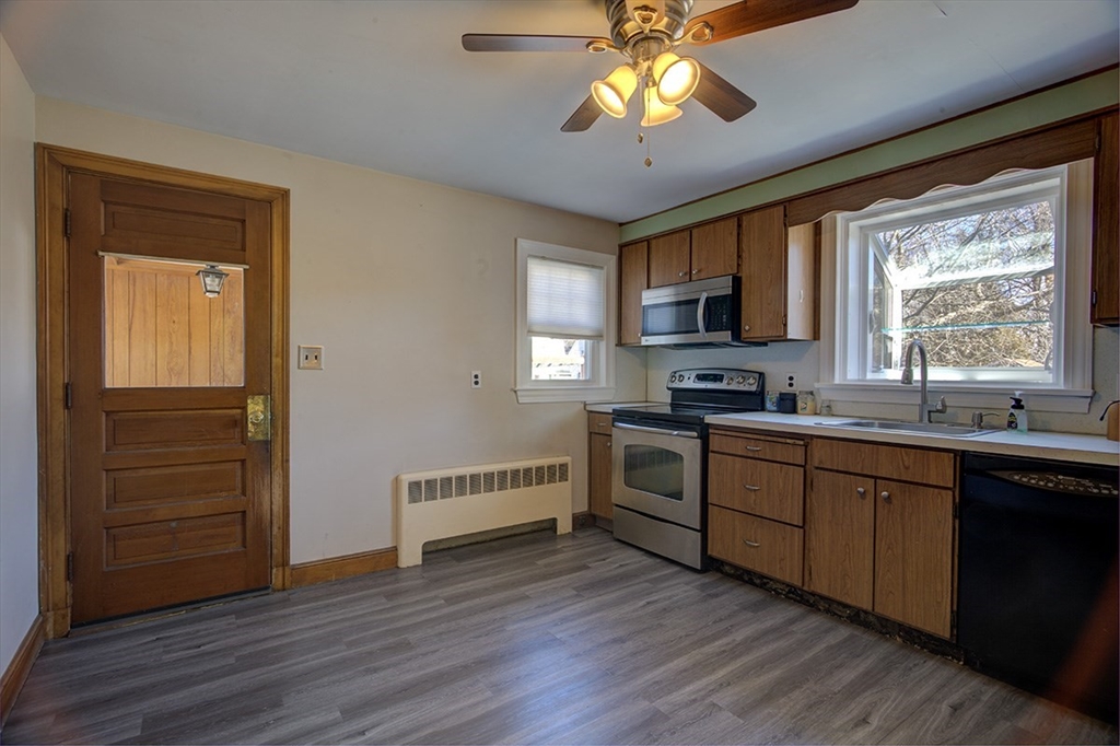 29 Perley Street Lynn, MA 01905 - Photo 8 of 27 a kitchen with stainless steel appliances granite countertop a stove cabinets and wooden floor