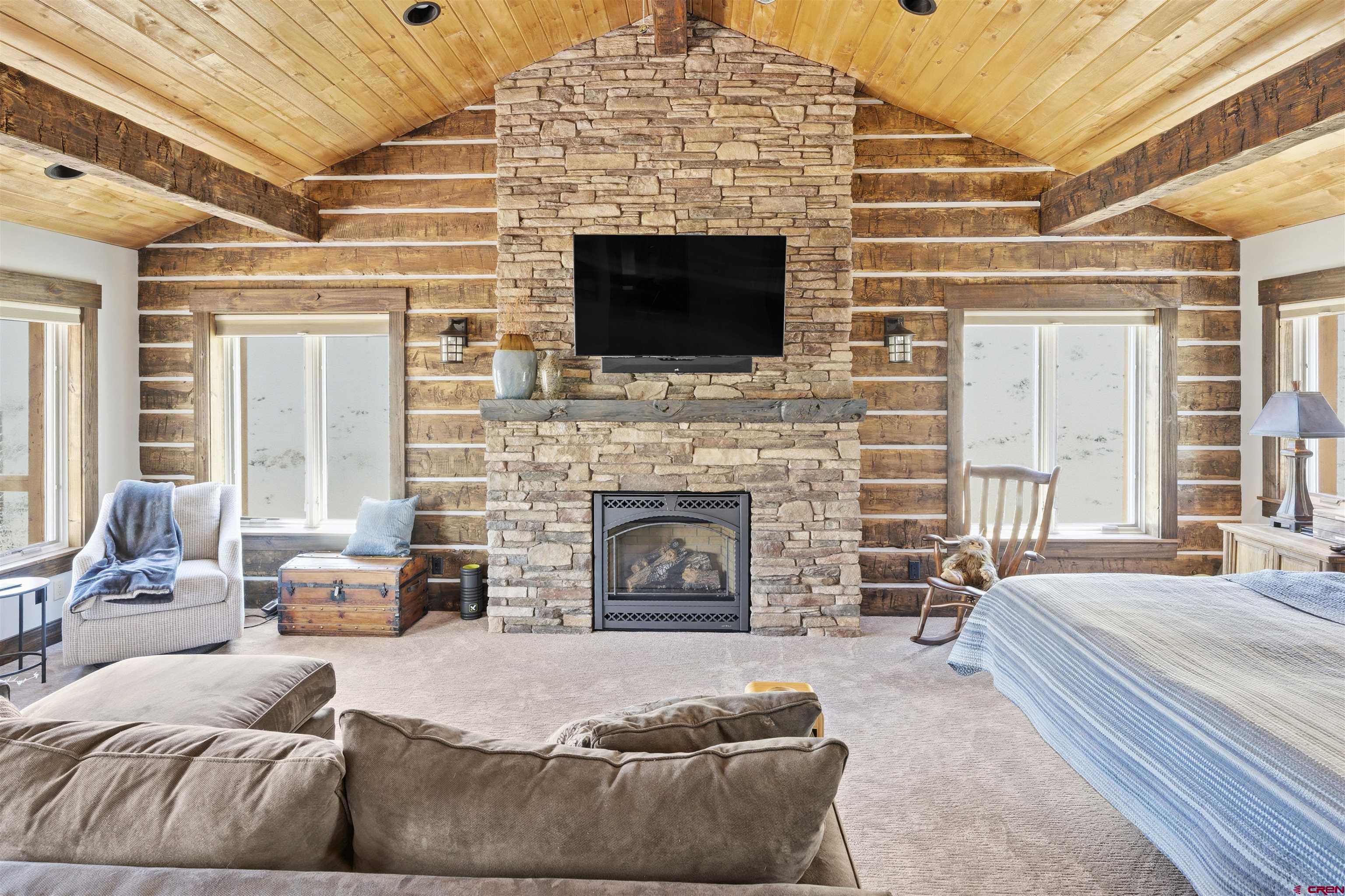684 Falcon Way Montrose, CO 81403 - Photo 12 of 43 a living room with furniture a fireplace and a flat screen tv
