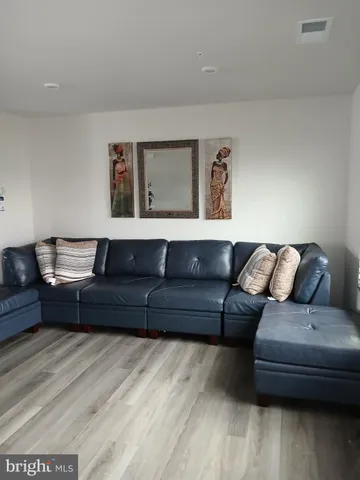 a living room with furniture and painting on the wall