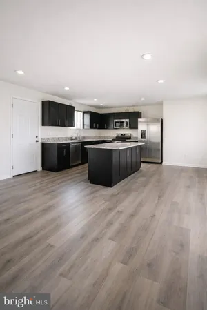 a living room with a couch and a wooden floor