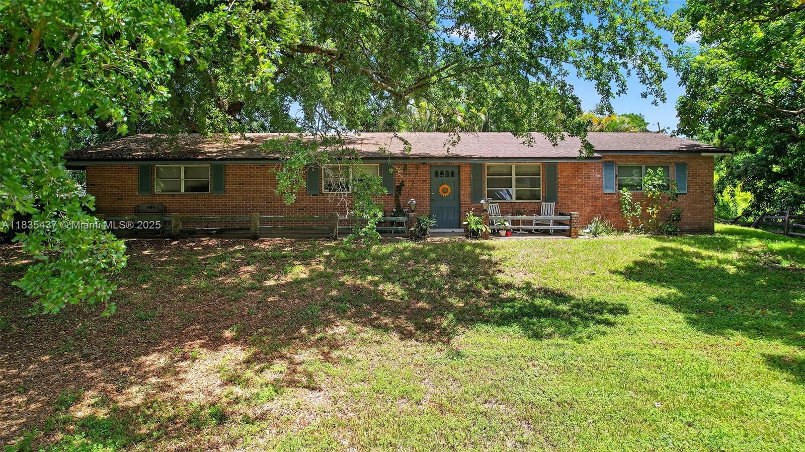 13851 Southwest 26th Street Davie, FL 33325 - Photo 14 of 48 a front view of a house with garden