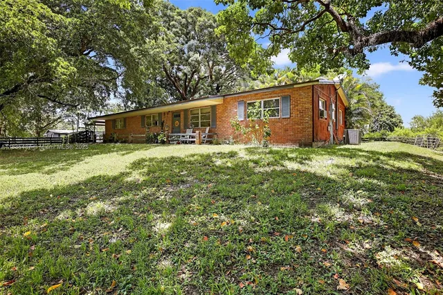a backyard of a house with yard and outdoor seating