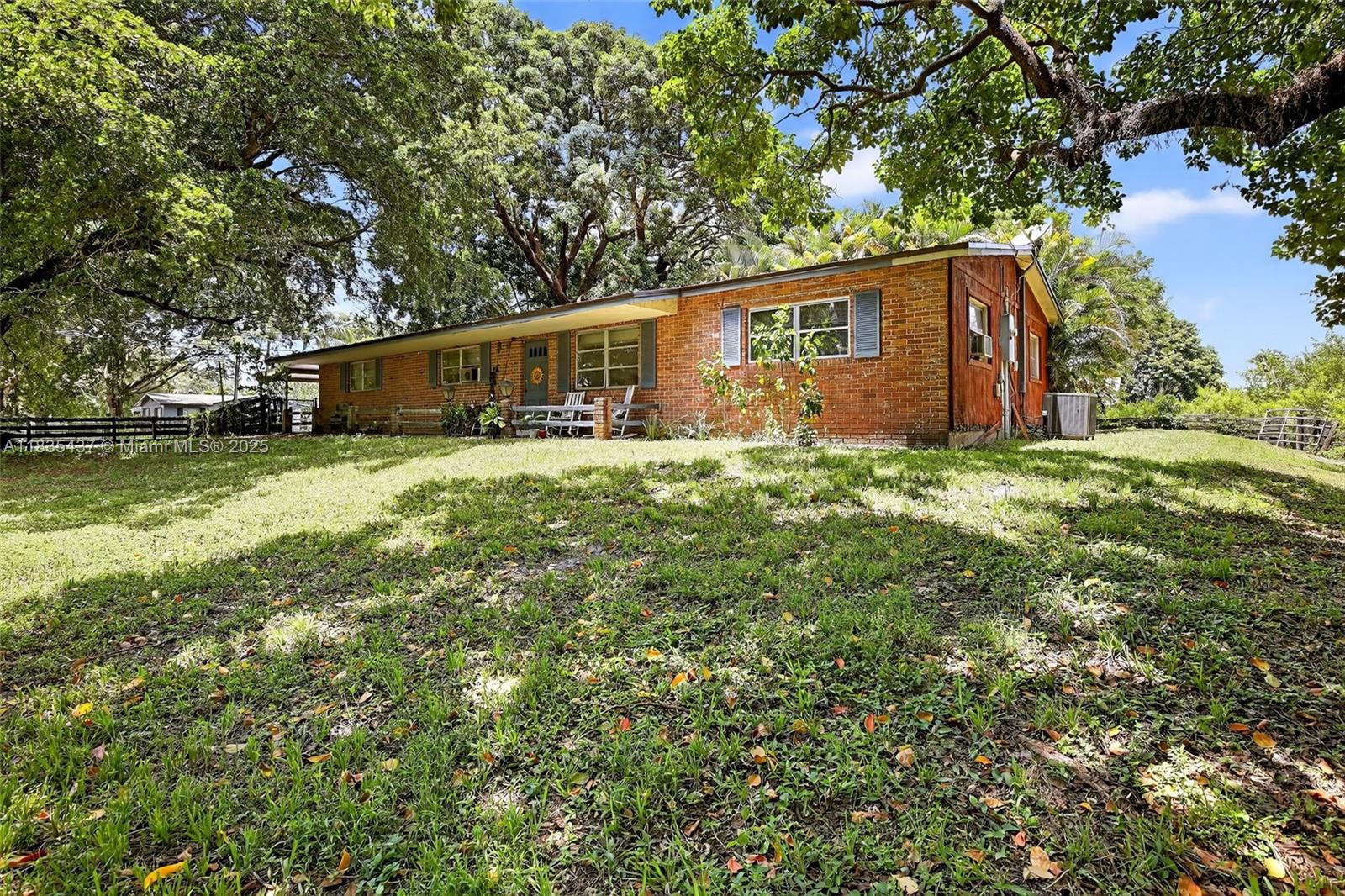 13851 Southwest 26th Street Davie, FL 33325 - Photo 15 of 48 a backyard of a house with yard and outdoor seating