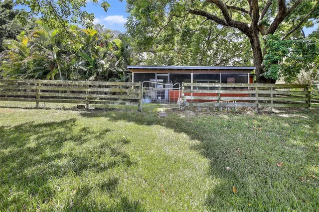 a view of backyard with deck and green space