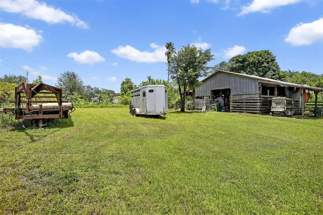 a view of a house with a yard and sitting area