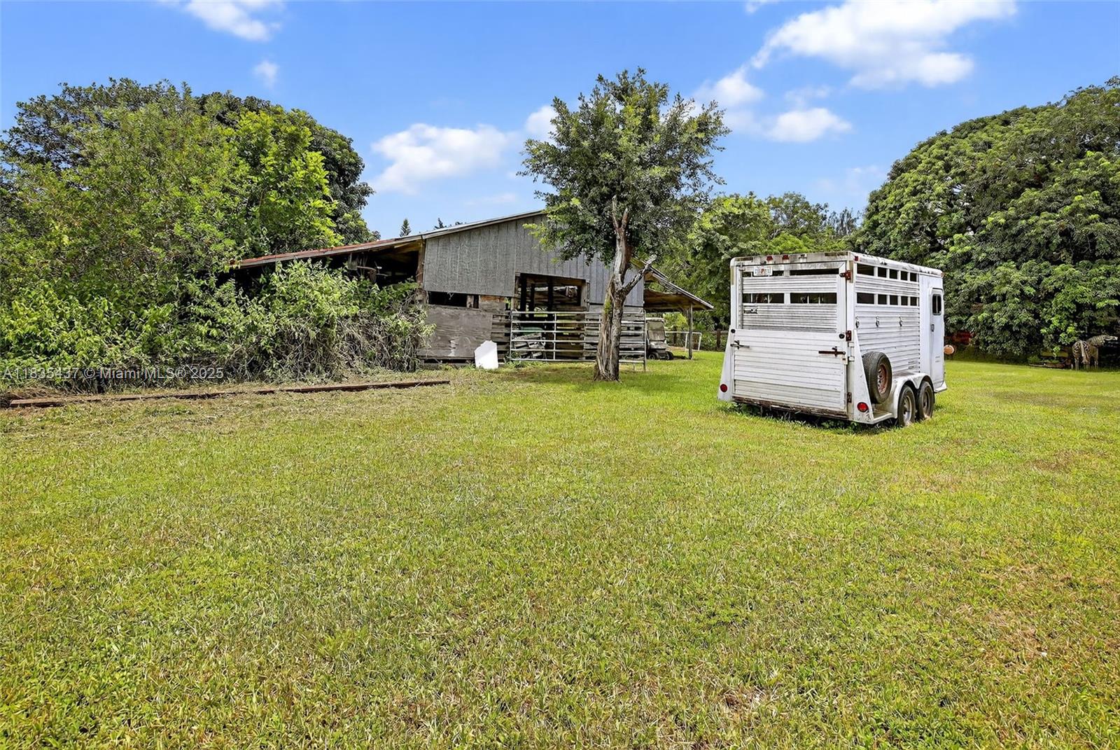 13851 Southwest 26th Street Davie, FL 33325 - Photo 29 of 48 a front view of a house with a garden and tree