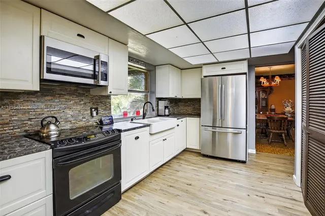 a kitchen with a stove a sink and a refrigerator