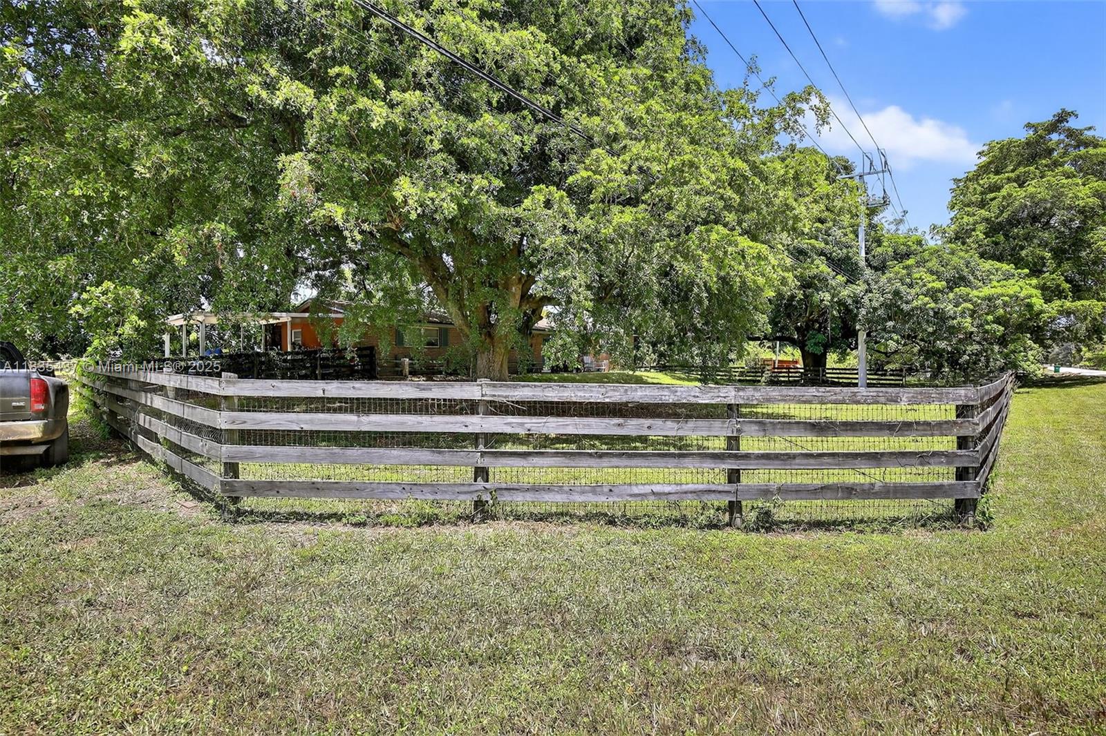 13851 Southwest 26th Street Davie, FL 33325 - Photo 31 of 48 a view of backyard with wooden fence and trees