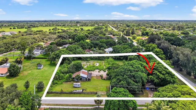 a view of a green field with an ocean view