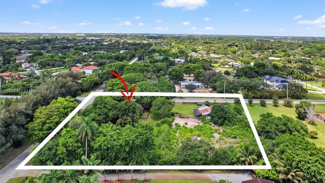 an aerial view of residential houses with outdoor space and street view