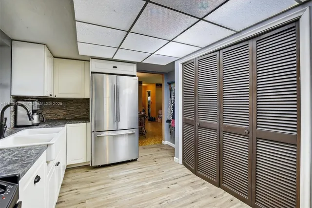 a kitchen with stainless steel appliances granite countertop a refrigerator and a sink