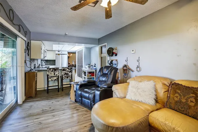 a living room with furniture and kitchen view
