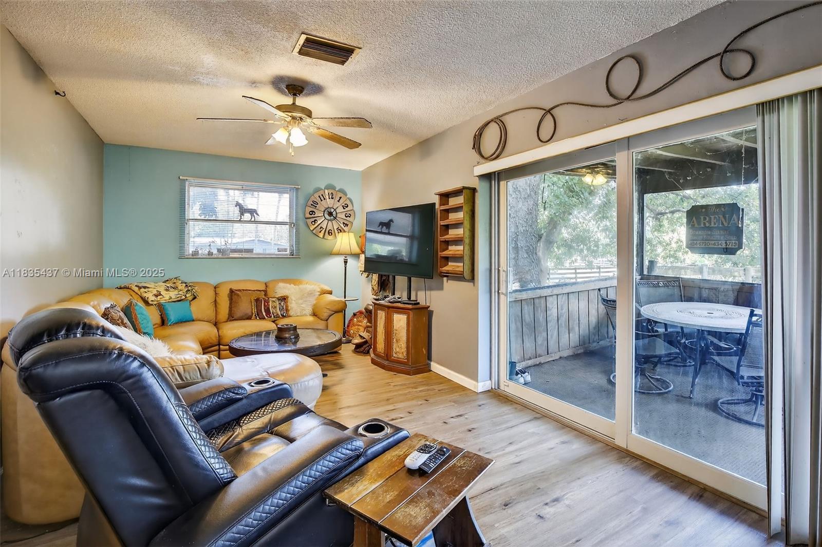 13851 Southwest 26th Street Davie, FL 33325 - Photo 7 of 48 a living room with furniture and a floor to ceiling window
