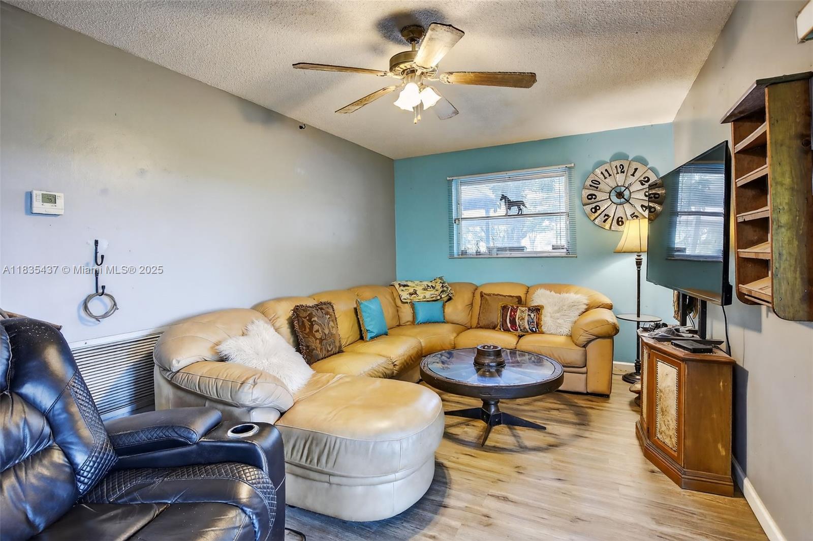 13851 Southwest 26th Street Davie, FL 33325 - Photo 8 of 48 a living room with furniture a flat screen tv and a table