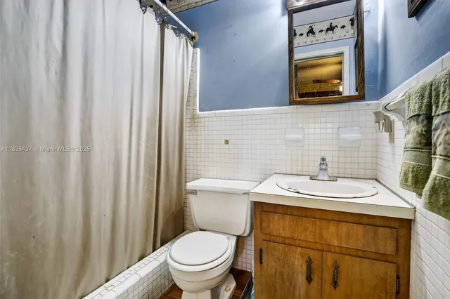 a bathroom with a sink toilet and mirror
