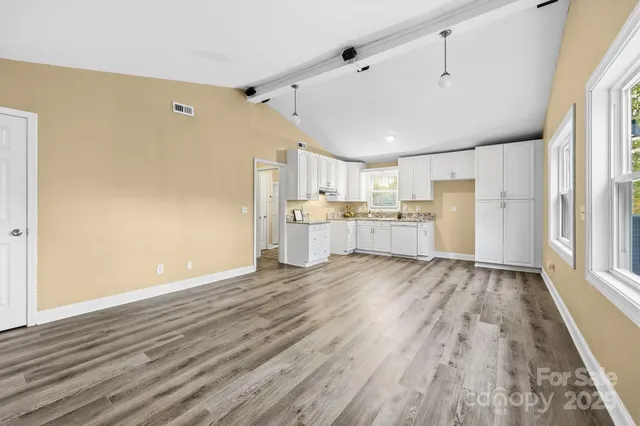 a view of a kitchen with wooden floor