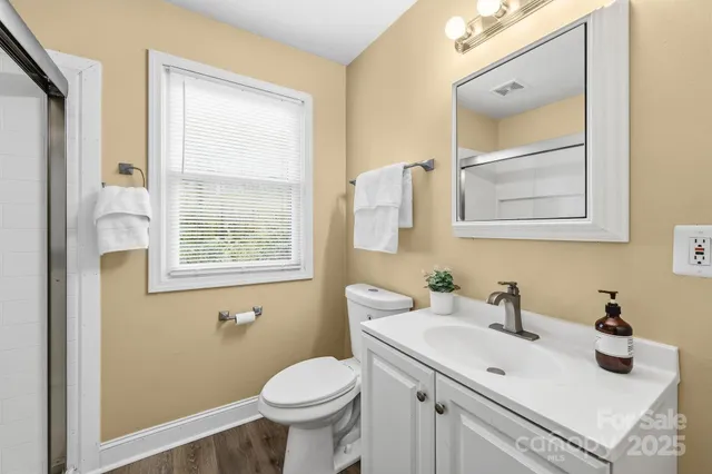 a bathroom with a glass shower door