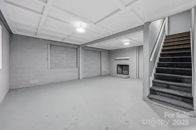 a view of empty room with a fireplace