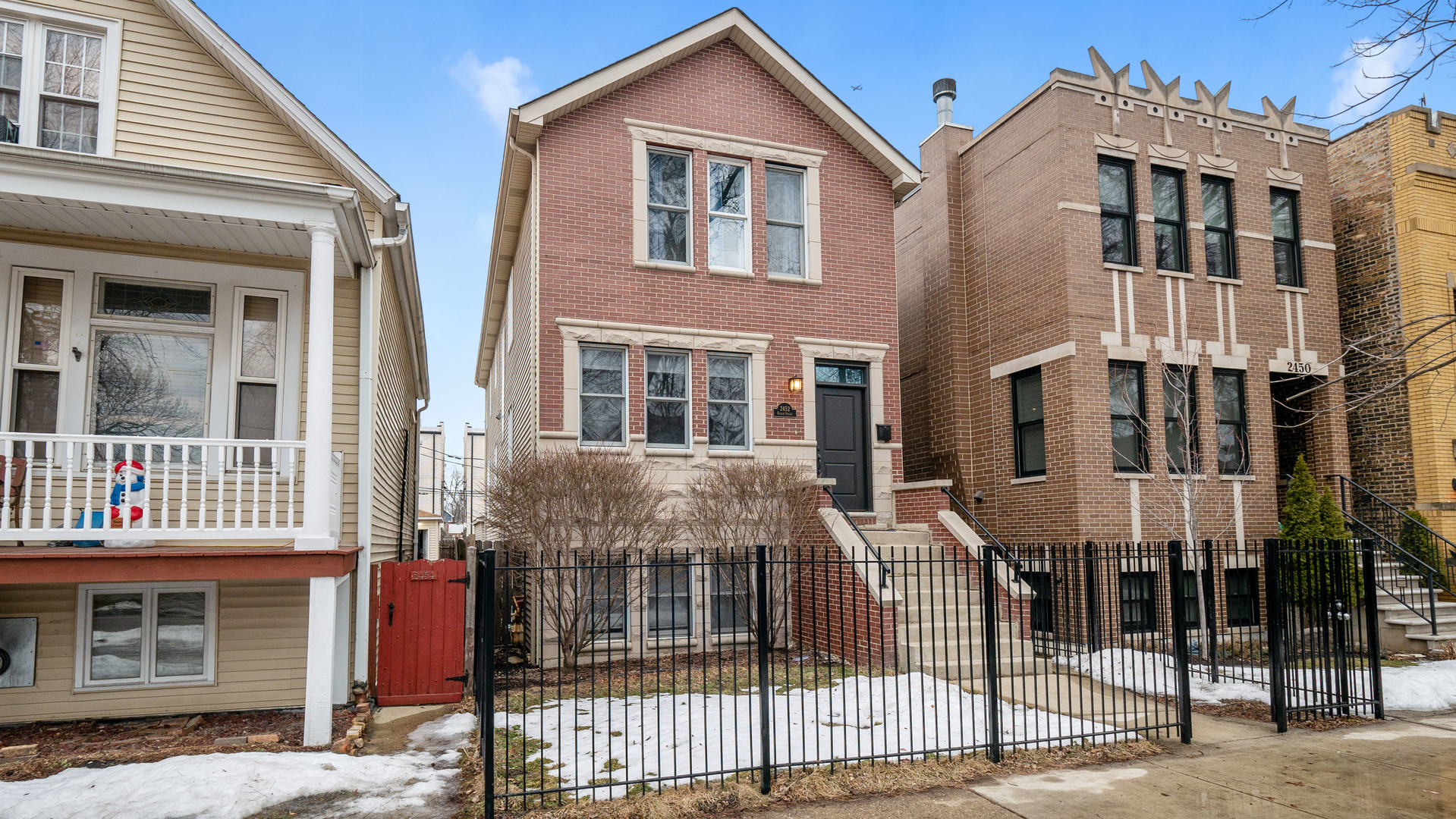 2452 West Dakin Street Chicago, IL 60618 - Photo 1 of 39 a front view of a building with glass windows