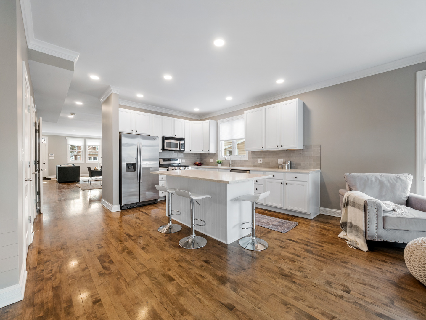2452 West Dakin Street Chicago, IL 60618 - Photo 13 of 39 a kitchen with white cabinets and stainless steel appliances