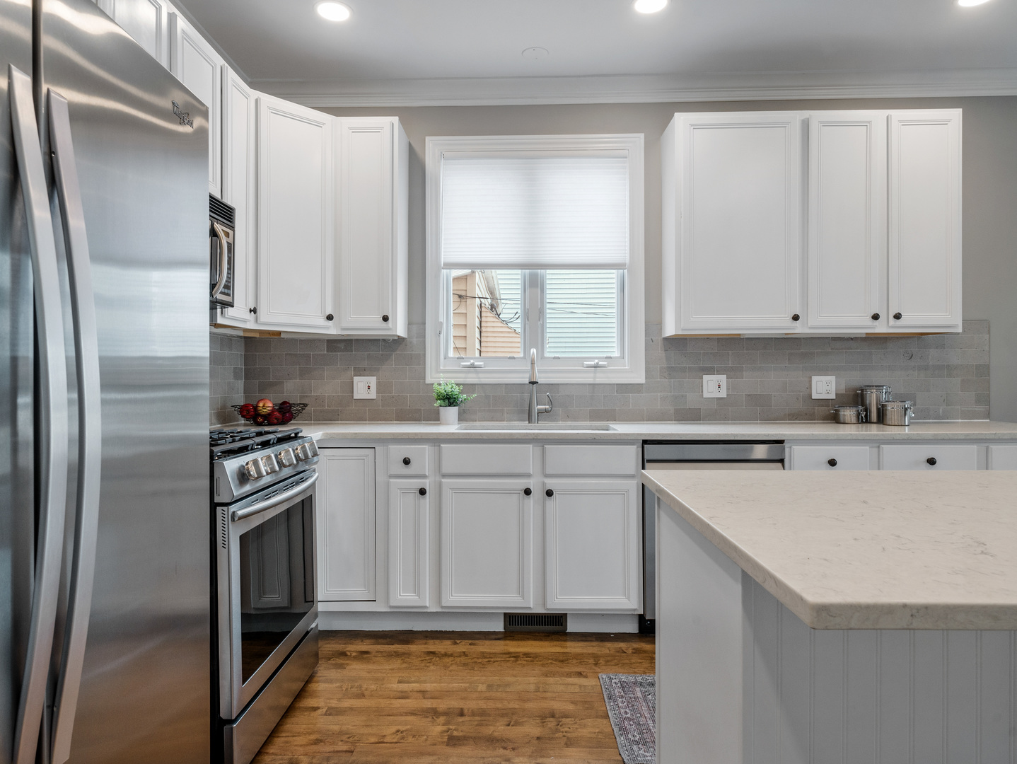 2452 West Dakin Street Chicago, IL 60618 - Photo 14 of 39 a kitchen with stainless steel appliances granite countertop a stove a sink and a refrigerator