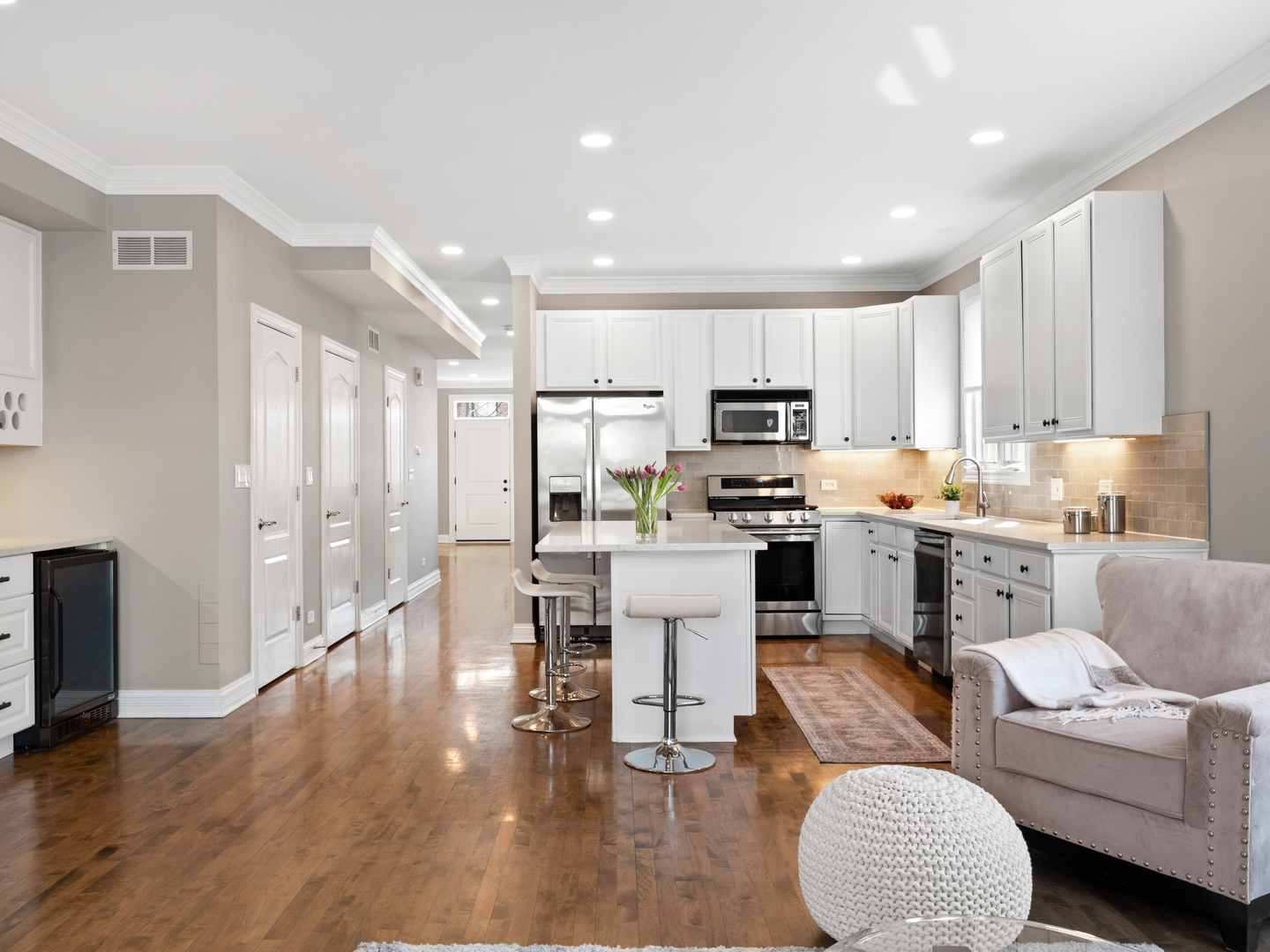 2452 West Dakin Street Chicago, IL 60618 - Photo 17 of 39 a kitchen with white cabinets and stainless steel appliances
