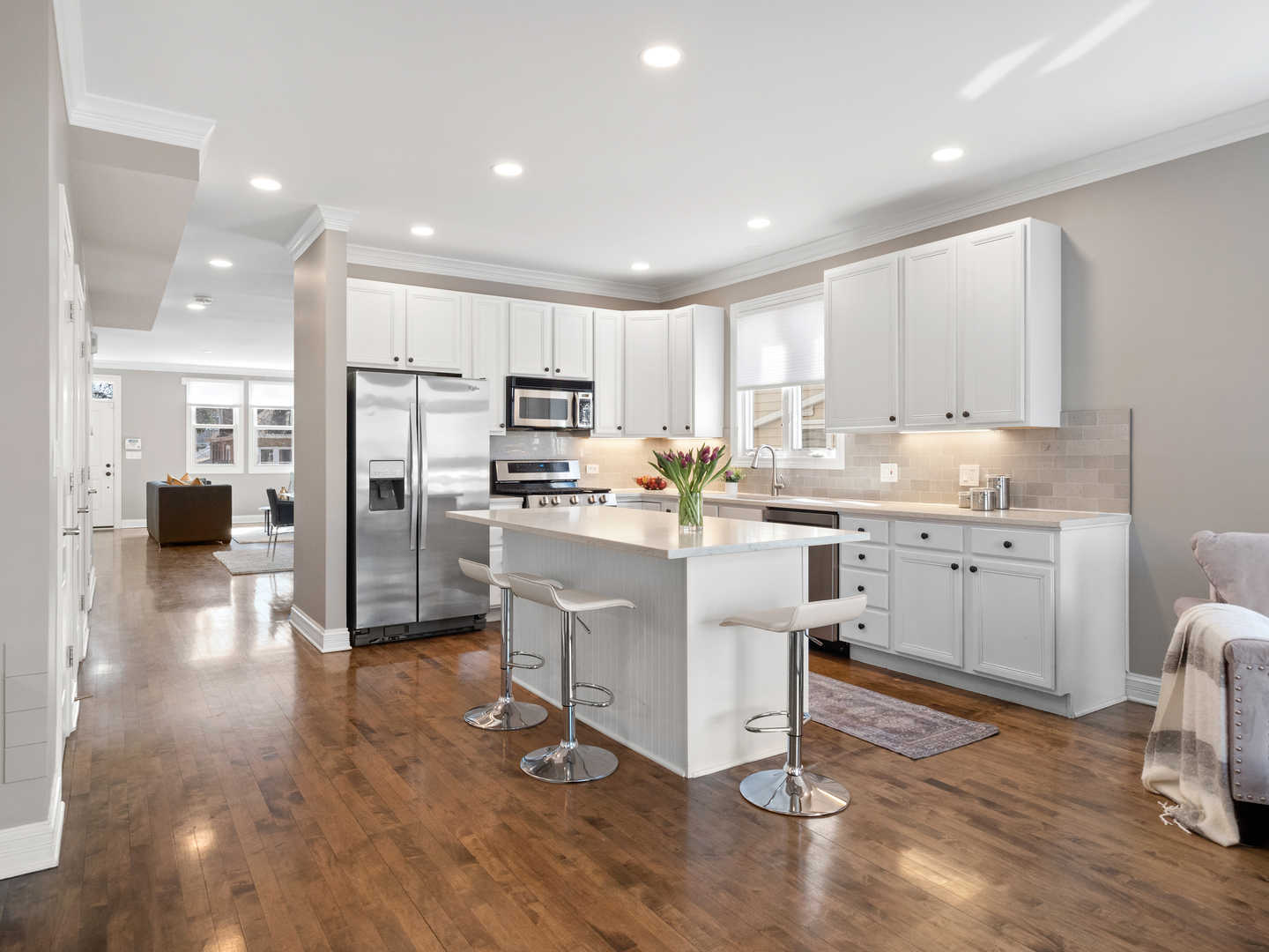 2452 West Dakin Street Chicago, IL 60618 - Photo 18 of 39 a kitchen with white cabinets and stainless steel appliances