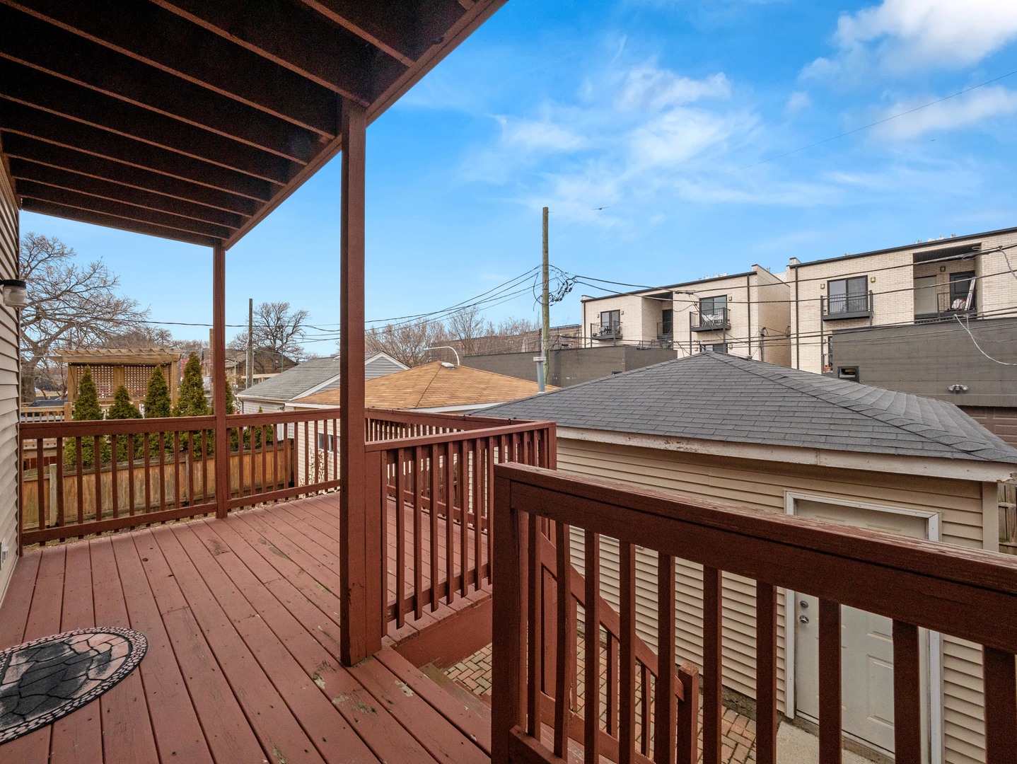 2452 West Dakin Street Chicago, IL 60618 - Photo 22 of 39 a view of a balcony with wooden floor and fence