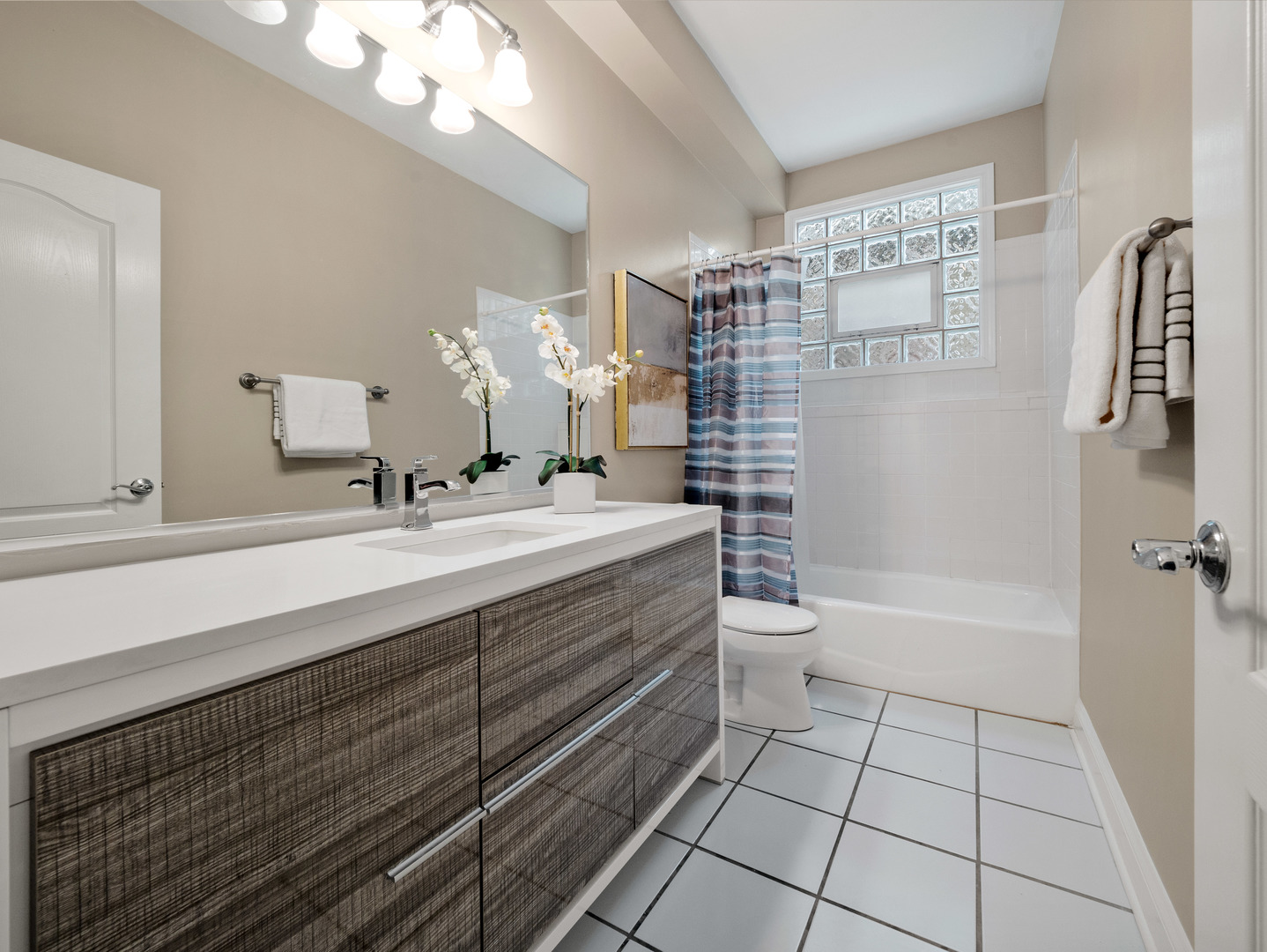 2452 West Dakin Street Chicago, IL 60618 - Photo 35 of 39 a bathroom with a double vanity sink a toilet and a shower