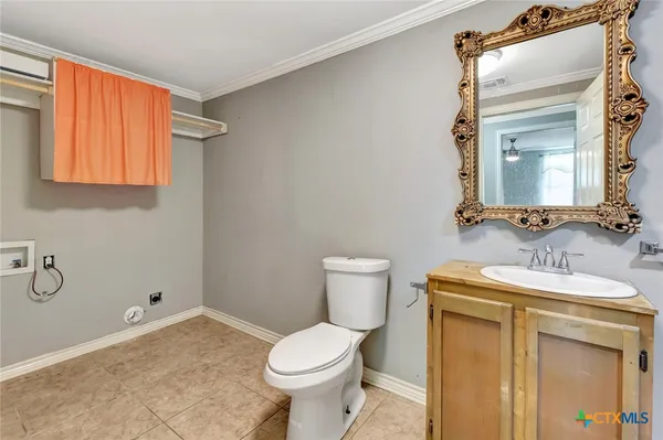a bathroom with a sink toilet and mirror