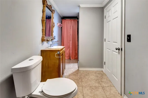 a white toilet sitting next to a bathroom sink