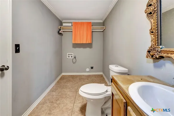 a white toilet sitting next to a bathroom sink