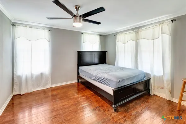 a living room with a bed and a chandelier
