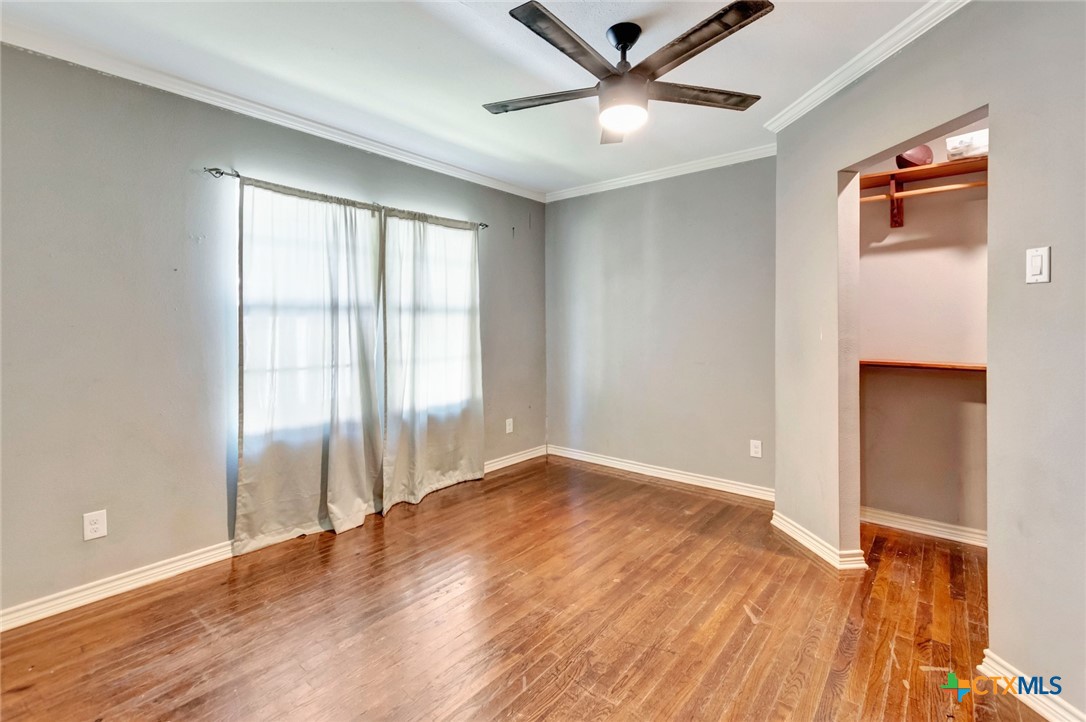 1303 East North Street Victoria, TX 77901 - Photo 22 of 36 wooden floor in an empty room with a window