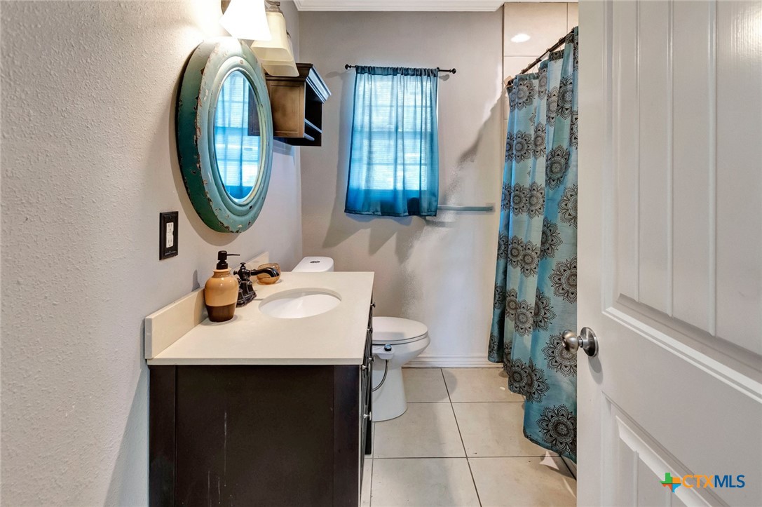 1303 East North Street Victoria, TX 77901 - Photo 24 of 36 a bathroom with a sink and a mirror