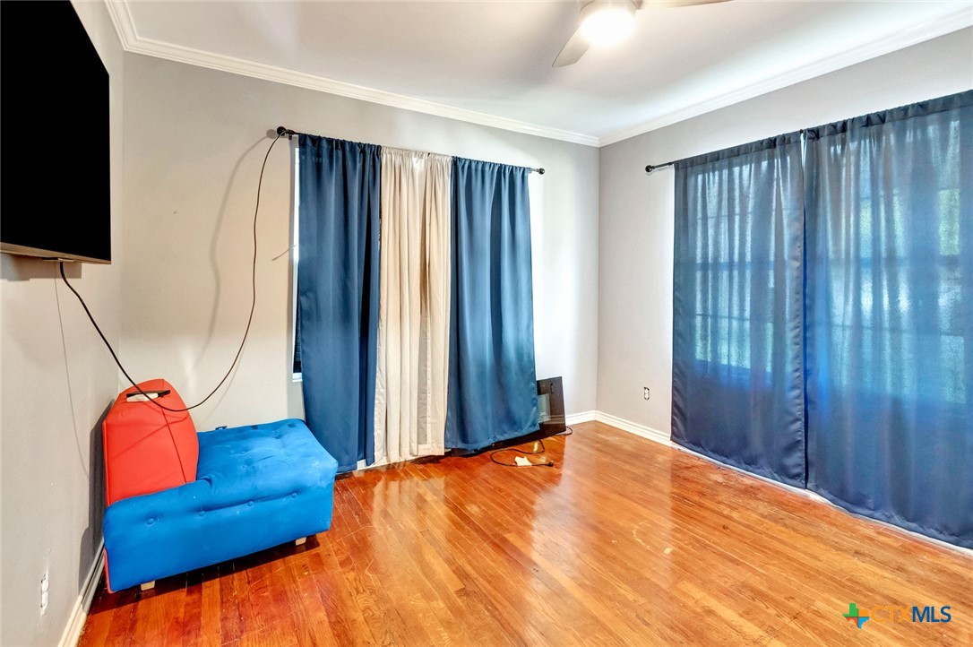 1303 East North Street Victoria, TX 77901 - Photo 25 of 36 a bedroom with a bed and wooden floor