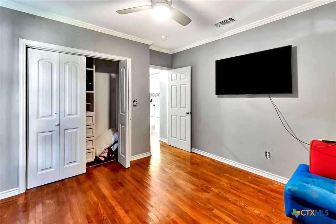 1303 East North Street Victoria, TX 77901 - Photo 26 of 36 a view of a livingroom with wooden floor and a flat screen tv