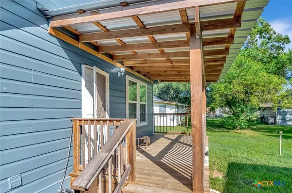 a balcony view with a backyard space