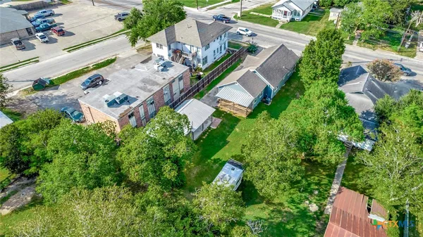 an aerial view of a house with a yard