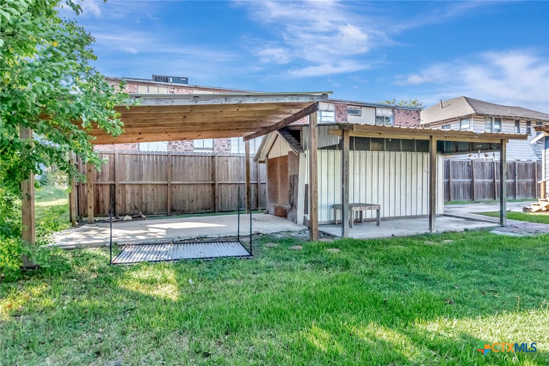 1303 East North Street Victoria, TX 77901 - Photo 33 of 36 a view of a house with a yard and wooden fence