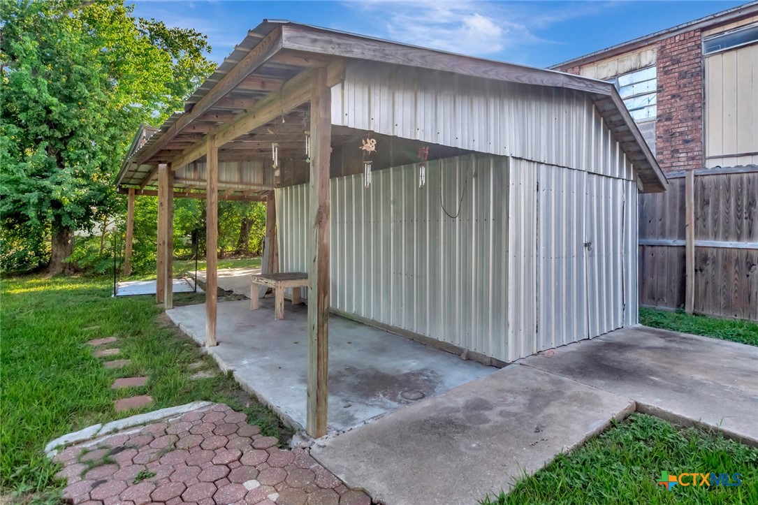 1303 East North Street Victoria, TX 77901 - Photo 35 of 36 a backyard of a house with plants and tree