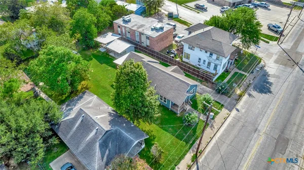 an aerial view of a house with garden space and street view