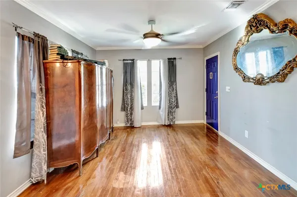 a view of a livingroom with wooden floor and a window