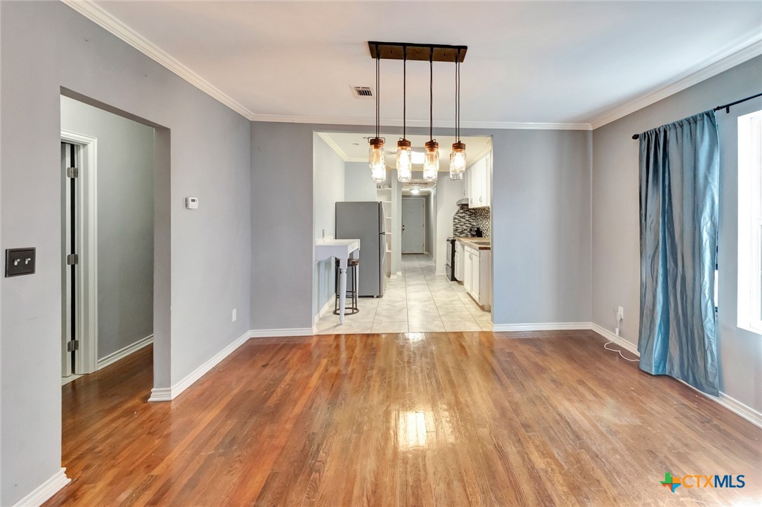 1303 East North Street Victoria, TX 77901 - Photo 9 of 36 a view of a livingroom with a chandelier