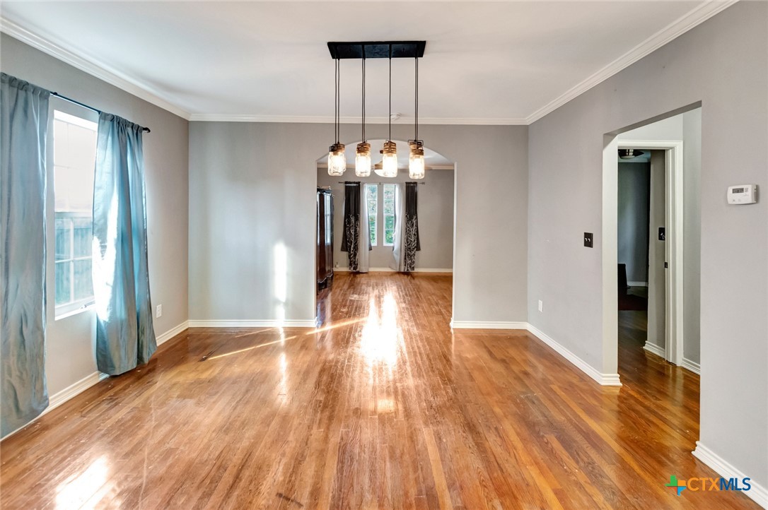 1303 East North Street Victoria, TX 77901 - Photo 10 of 36 a view of a livingroom with wooden floor and a large window